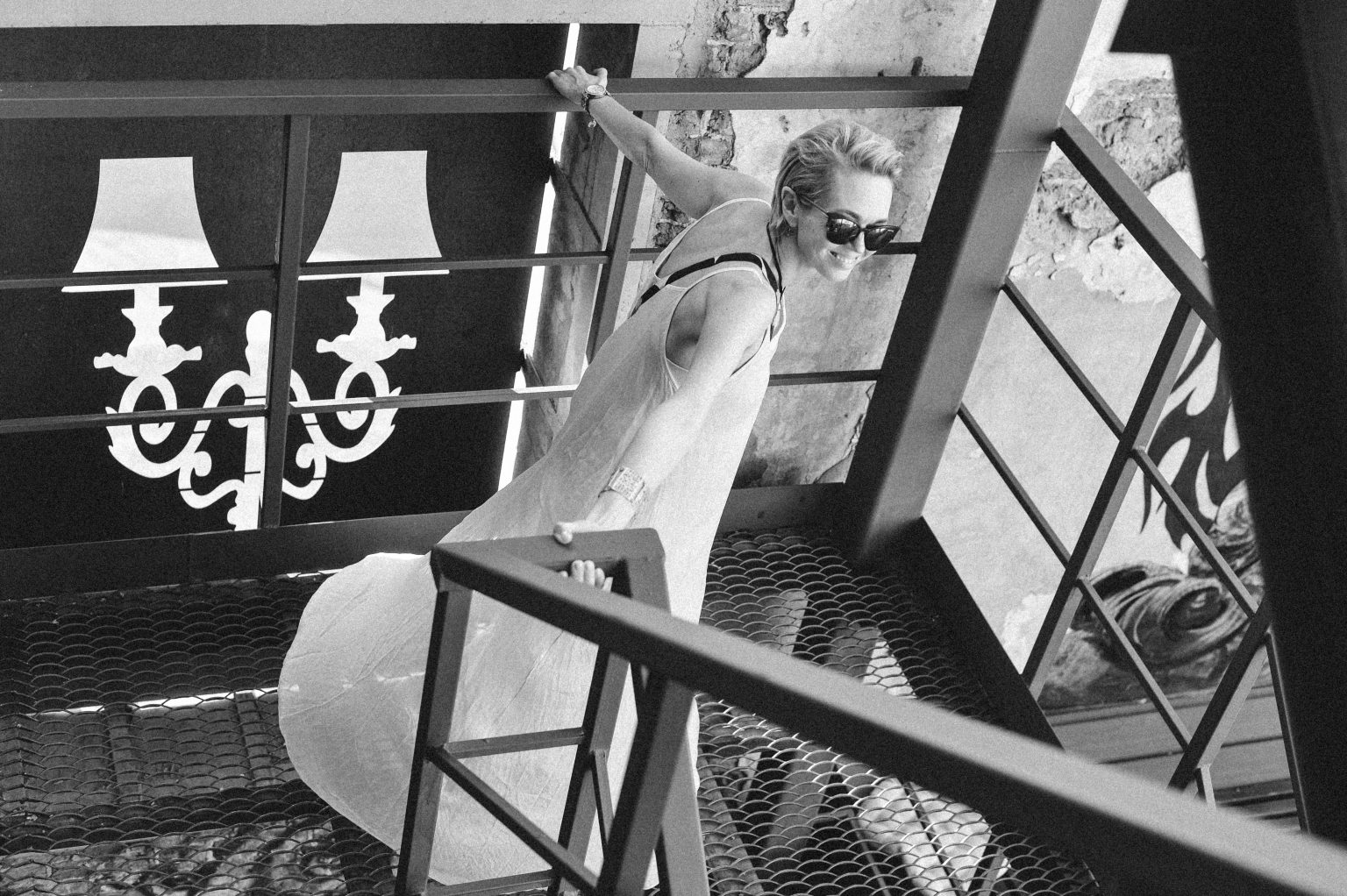 Woman in white dress walking down on the stairs